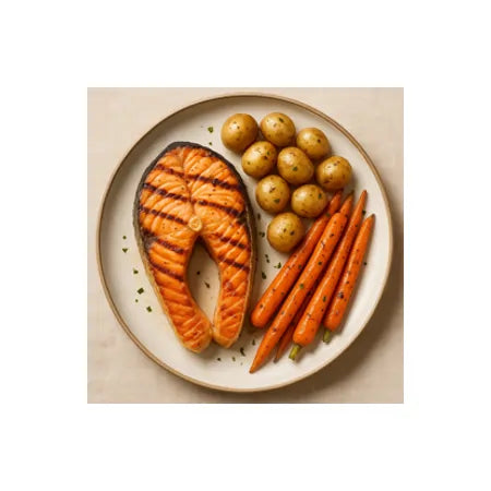 Grilled salmon steak served with roasted baby potatoes and glazed carrots on a plate