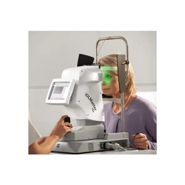Woman undergoing eye exam with IOLMaster machine in an ophthalmology clinic