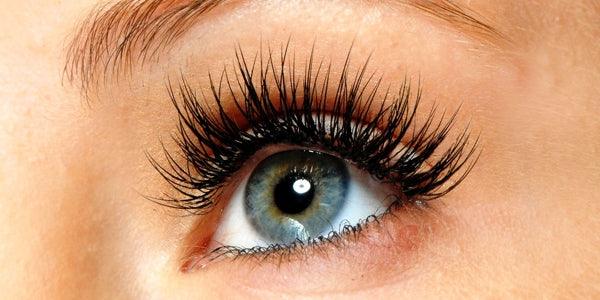 Close-up of a blue eye with long eyelashes, healthy eye appearance, eyelid care