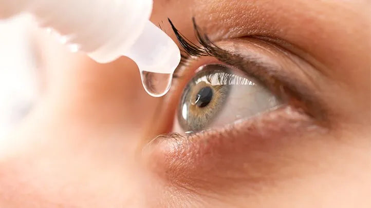 Close-up of eye with dropper applying dry eye relief eye drops
