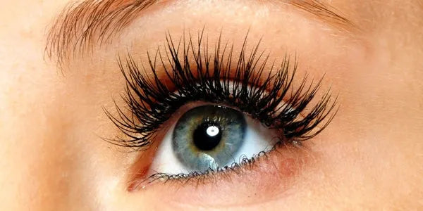 Close-up of a blue eye with long eyelashes, healthy skin, eye care focus